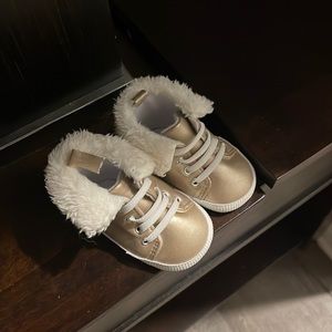 Gold high top shoes with fur trim